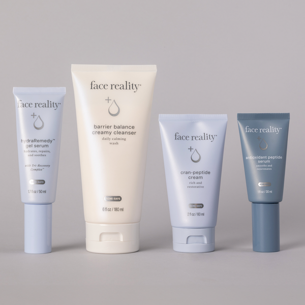Face Reality Age Defense Kit with 4 products: hydraRemedy™ Gel Serum, Barrier Balance Creamy Cleanser, Cran-Peptide Cream, and antioxidant peptide serum (left to right) against a light background.