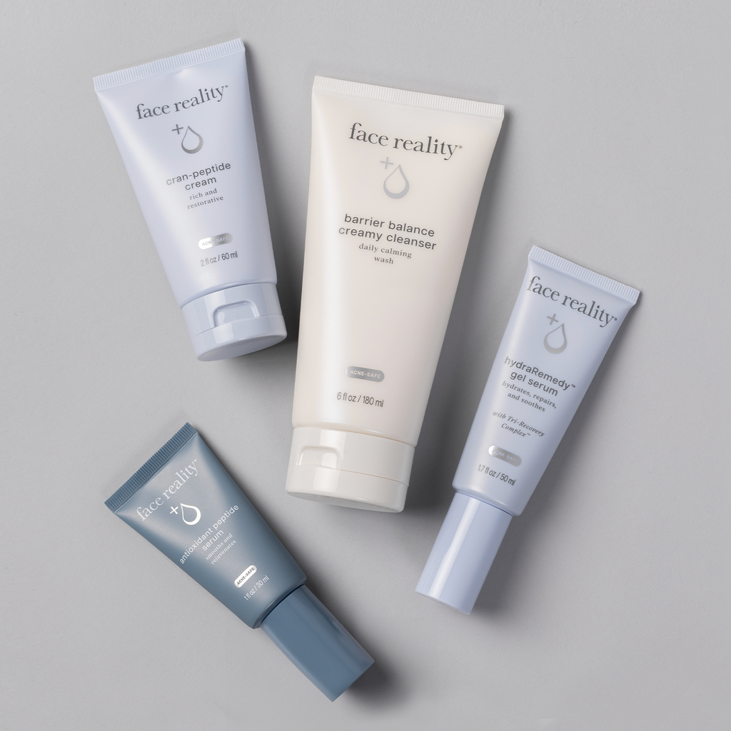 Face Reality Age Defense Kit including hydraRemedy™ Gel Serum, Barrier Balance Creamy Cleanser, Cran-Peptide Cream, and antioxidant peptide serum laying flat against light background