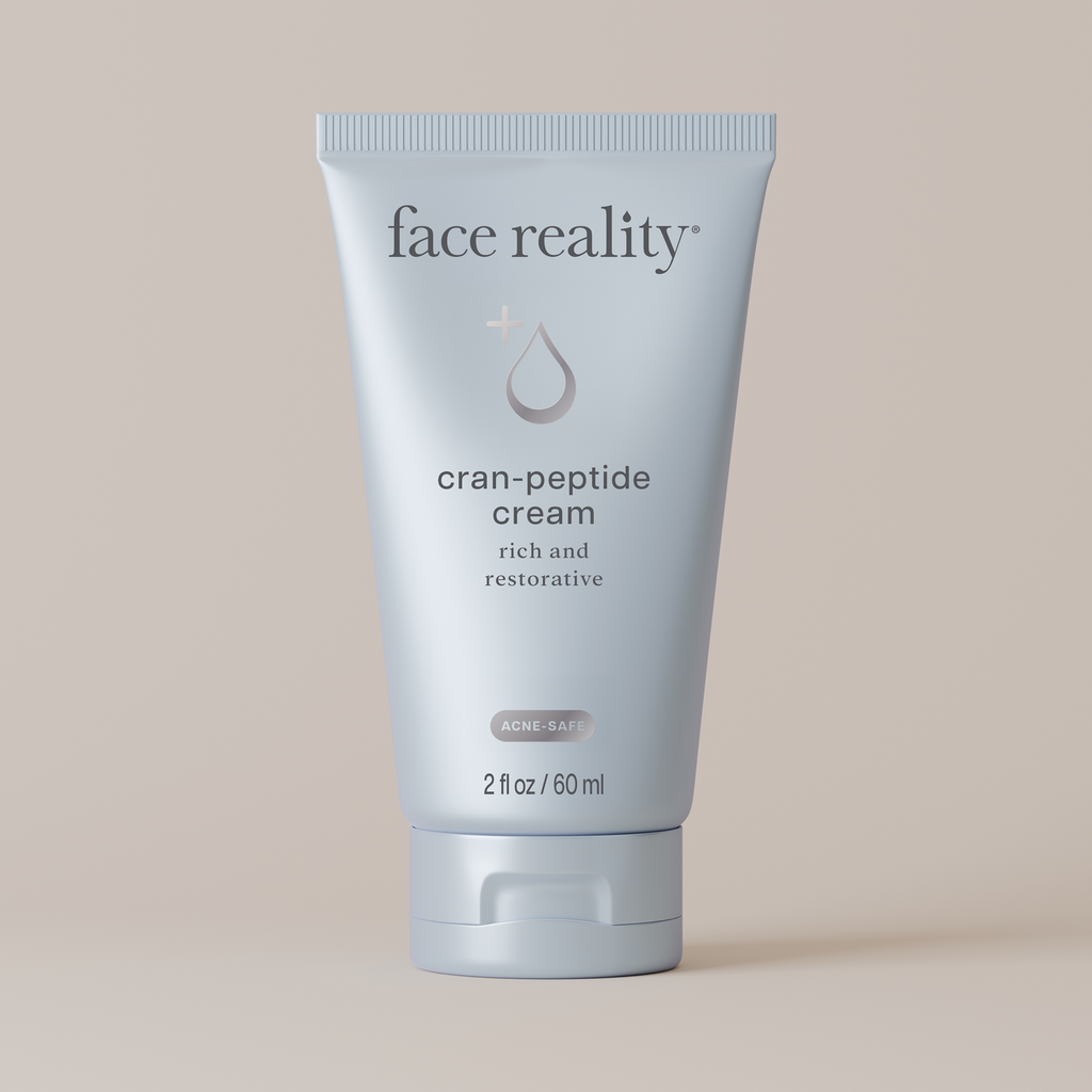 Tube of Face Reality cran-peptide cream on a beige background