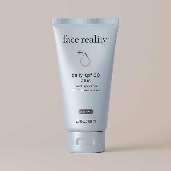 Tube of face reality daily SPF 30 plus sunscreen on a beige background