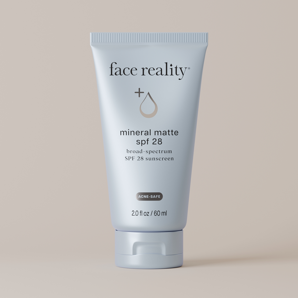 Tube of Face Reality mineral matte SPF 28 sunscreen on a beige background