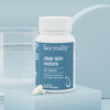 Bottle of Face Reality clear skin restore on a light blue background