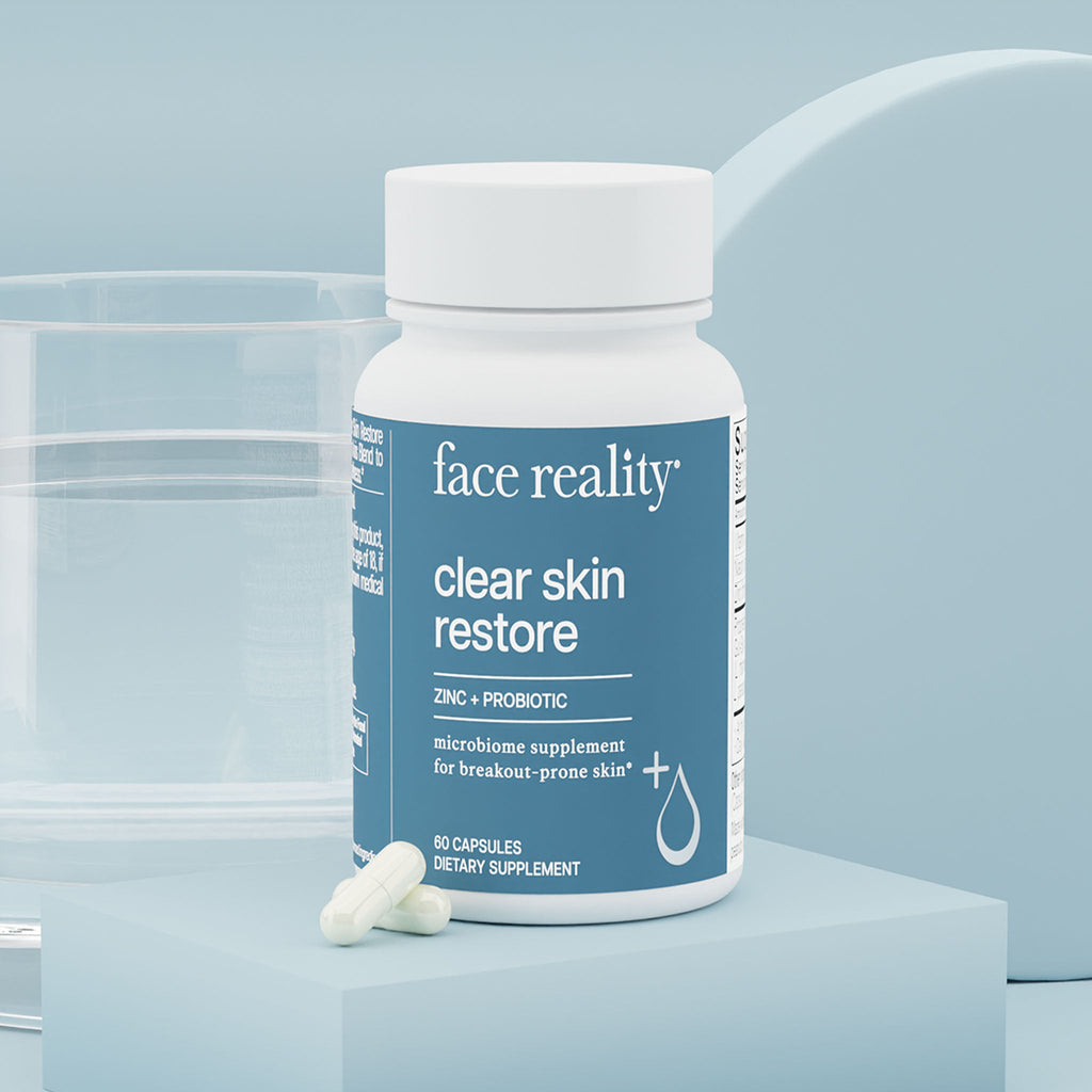 Bottle of Face Reality clear skin restore on a light blue background