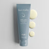 Tube of Face Reality sulfur spot treatment laying flat against light background with treatment swatches