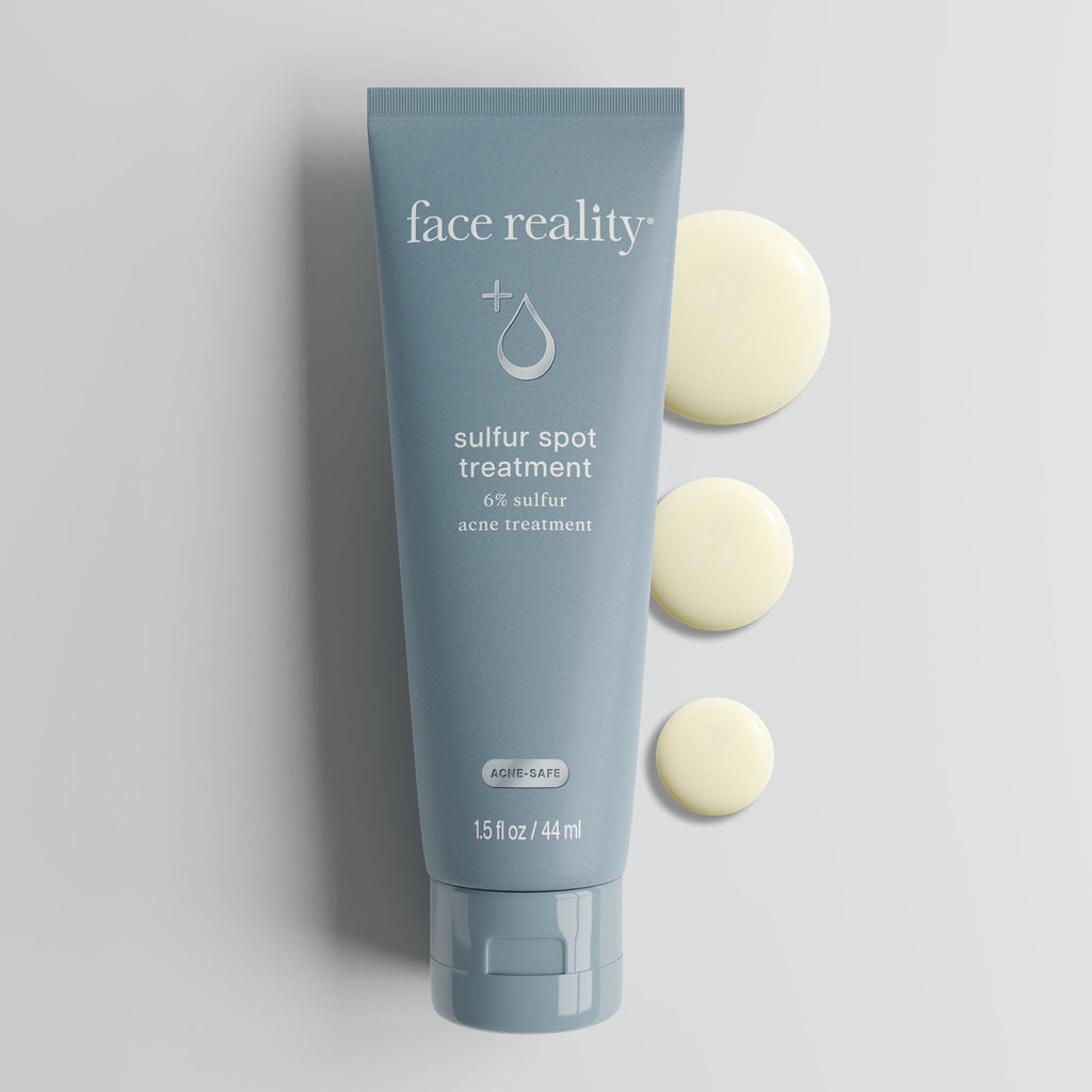 Tube of Face Reality sulfur spot treatment laying flat against light background with treatment swatches