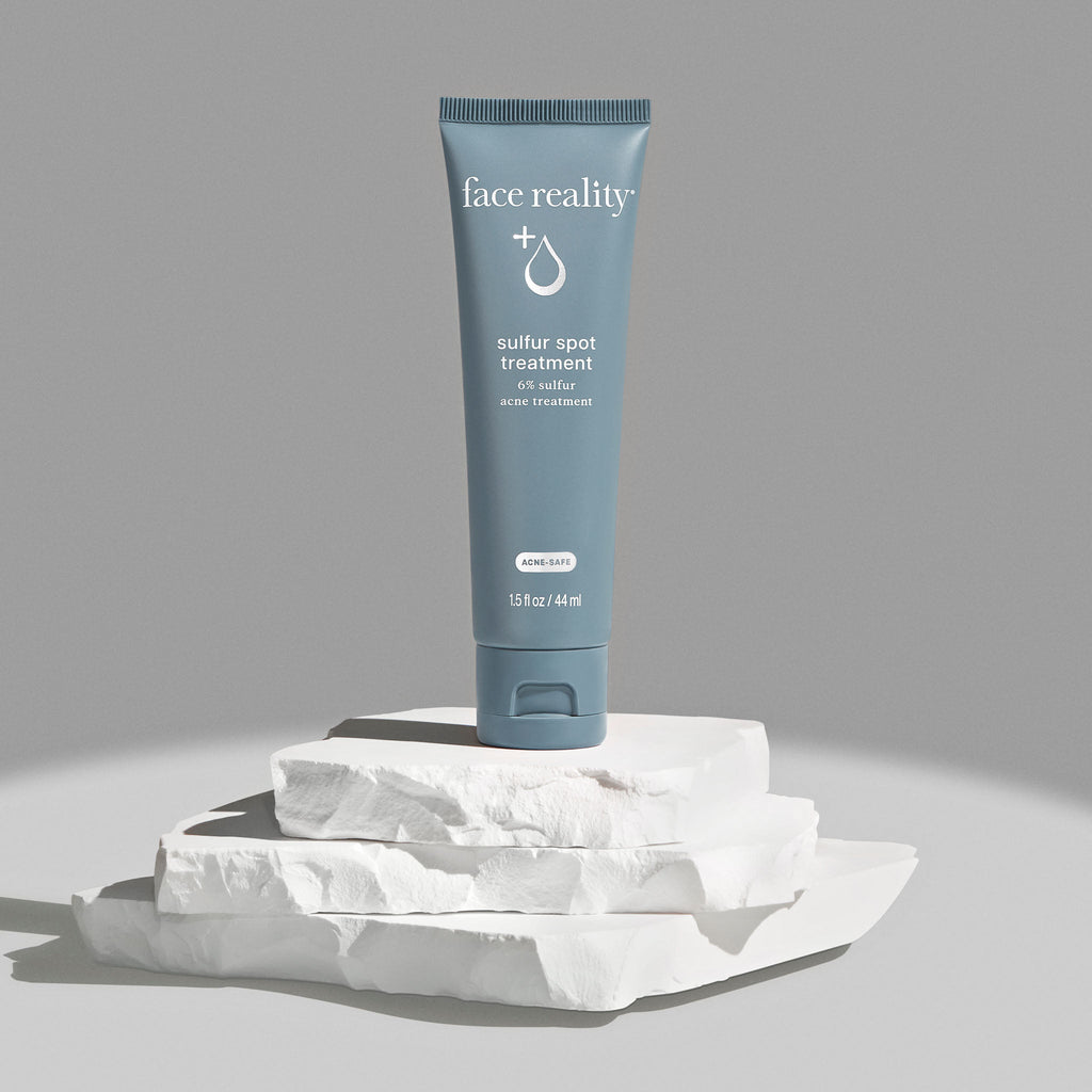 Tube of Face Reality sulfur spot treatment on a light gray background