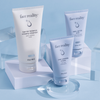 Face Reality Bottles for Acne prone skin Contents (3 products): barrier balance creamy cleanser, cran-peptide cream moisturizer, and daily spf 30 plus resting on blocks against light blue background