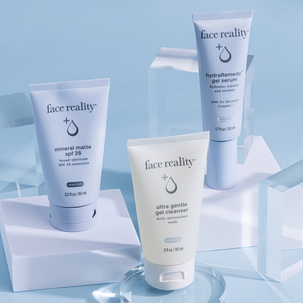 Face Reality Ultra gentle Cleanser, Hydraremedy gel serum and mineral matte spf 28 resting on blocks against light blue background
